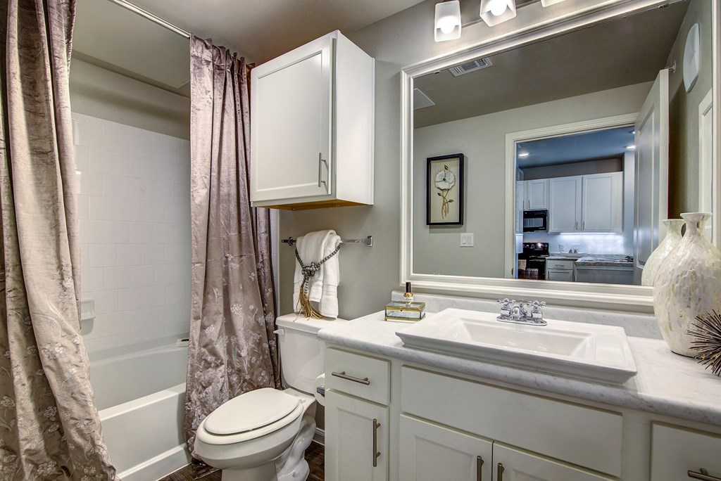 a bathroom with a toilet sink and bathtub