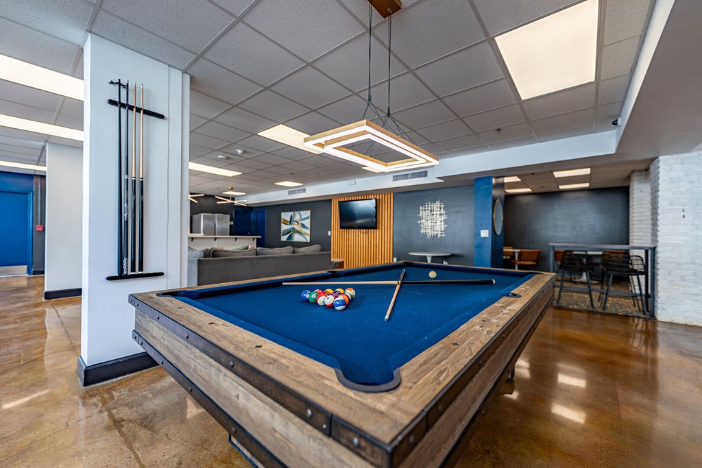 a billiards table in a room with a blue pool table