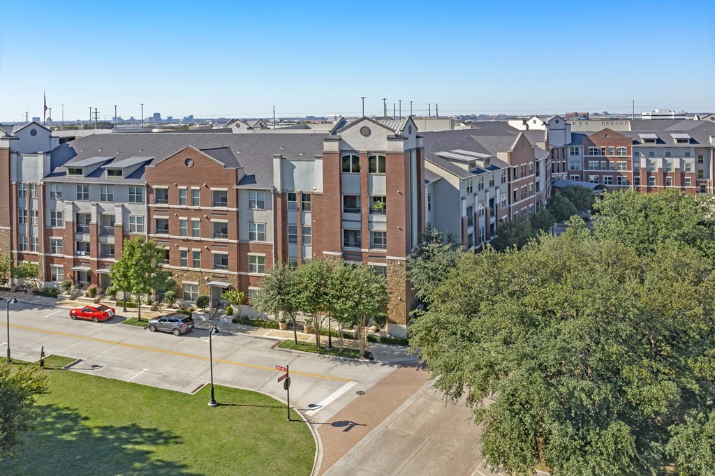 an aerial view of an apartment building on a city street
