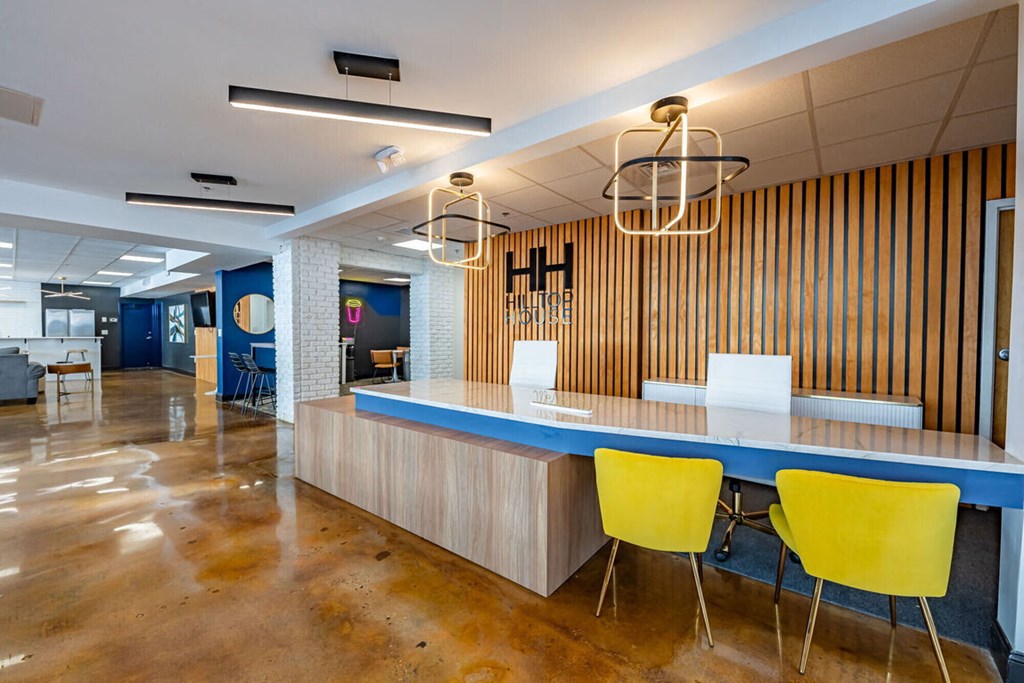 a conference room with a blue counter and yellow chairs
