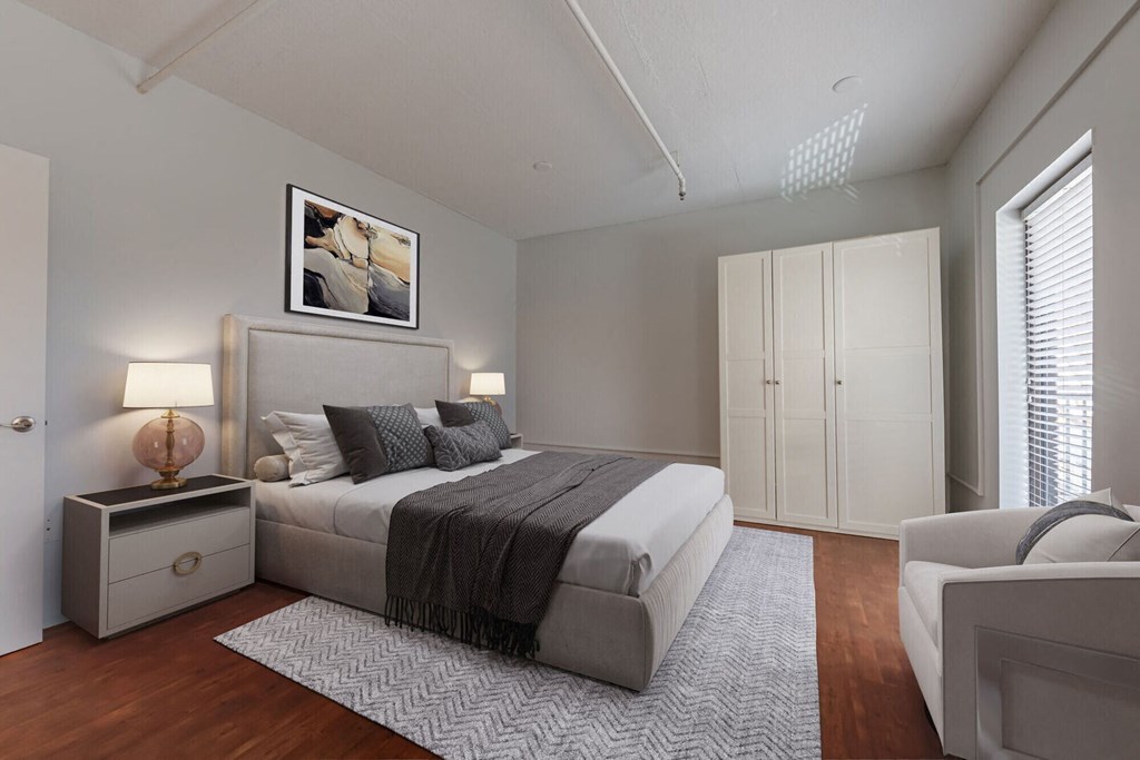 a bedroom with a large bed and a white couch