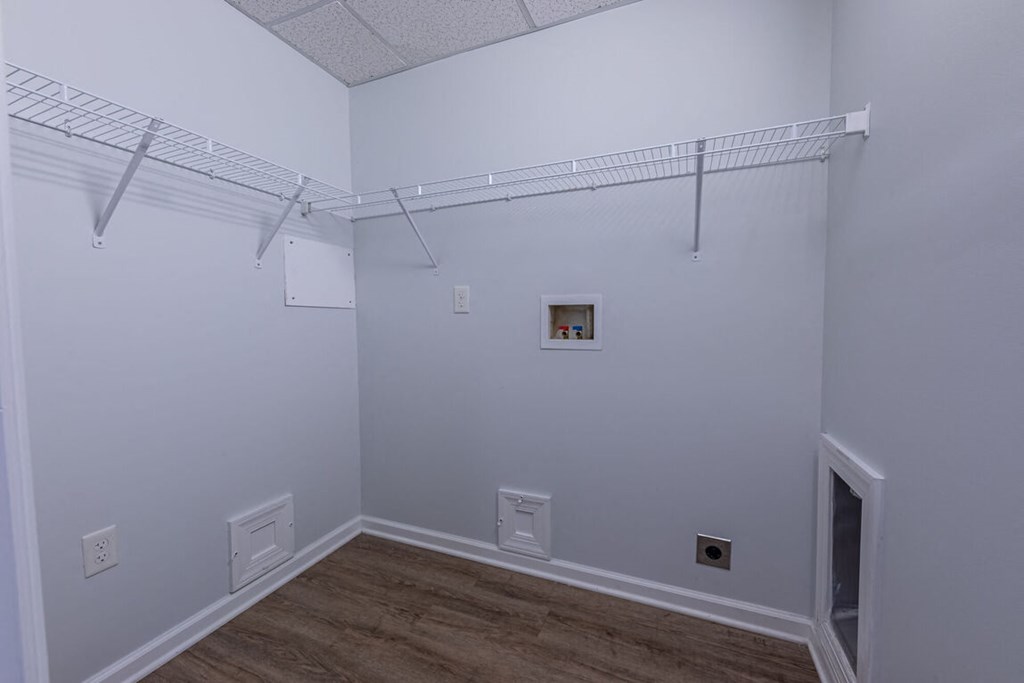 a large white room with a wood floor and white walls