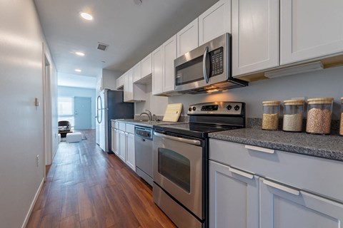 a kitchen with stainless steel appliances and white cabinets