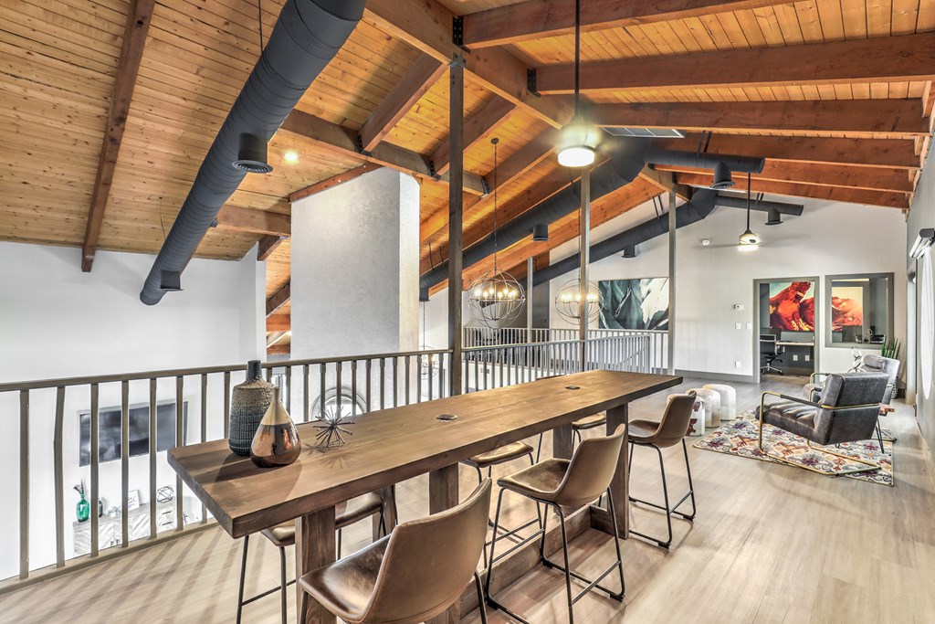 a dining room with a long wooden table and chairs