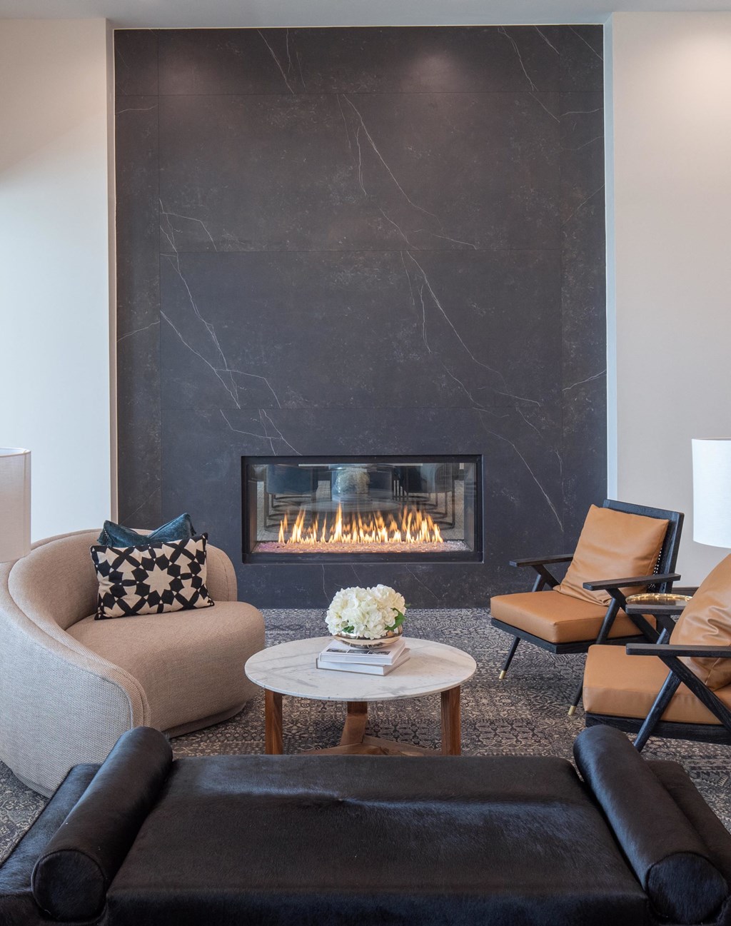 a living room with a fireplace and a couch and chairs