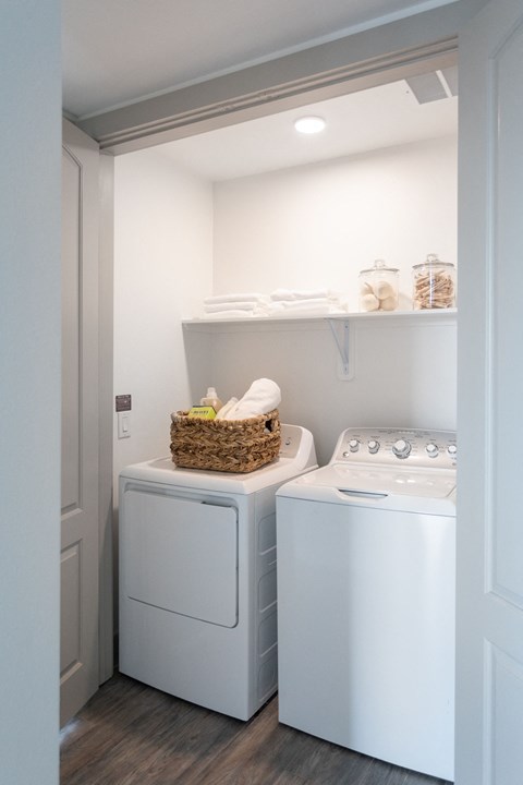 A small laundry room with a washer and dryer.