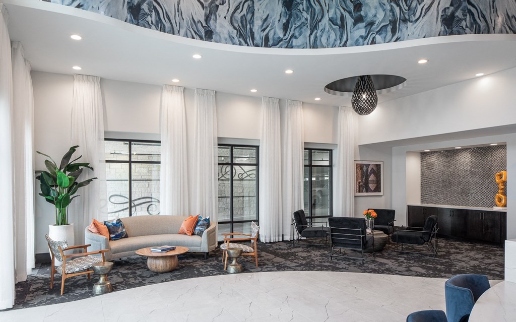 a living room with couches and chairs and a large window