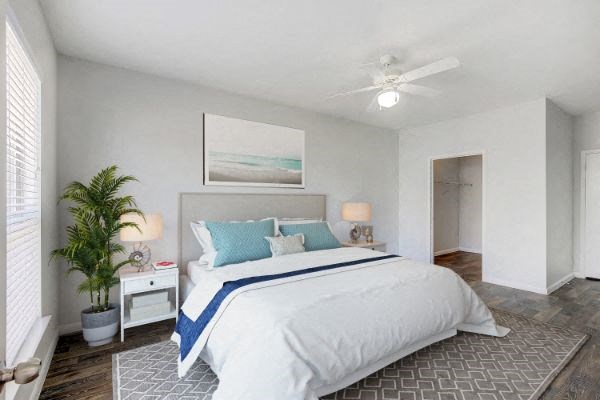 a bedroom with a bed and a ceiling fan