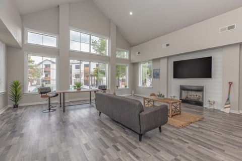 the heights club living room with fireplace and tv