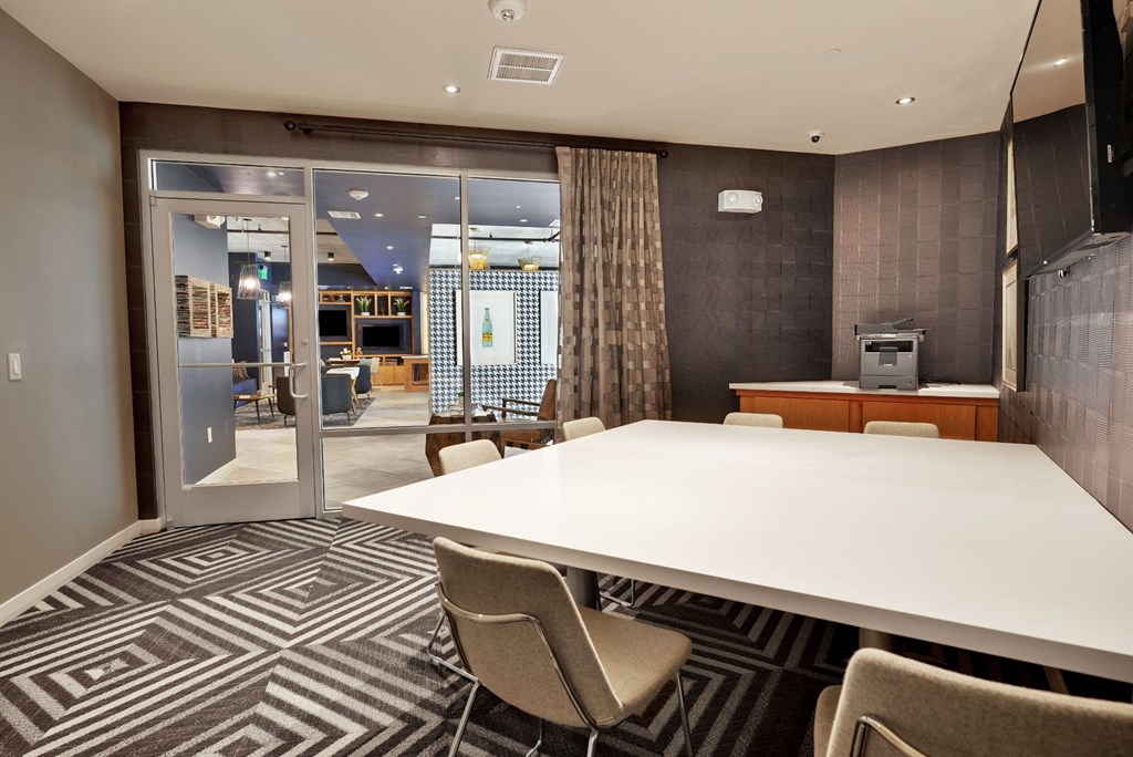 a meeting room with a large table and chairs