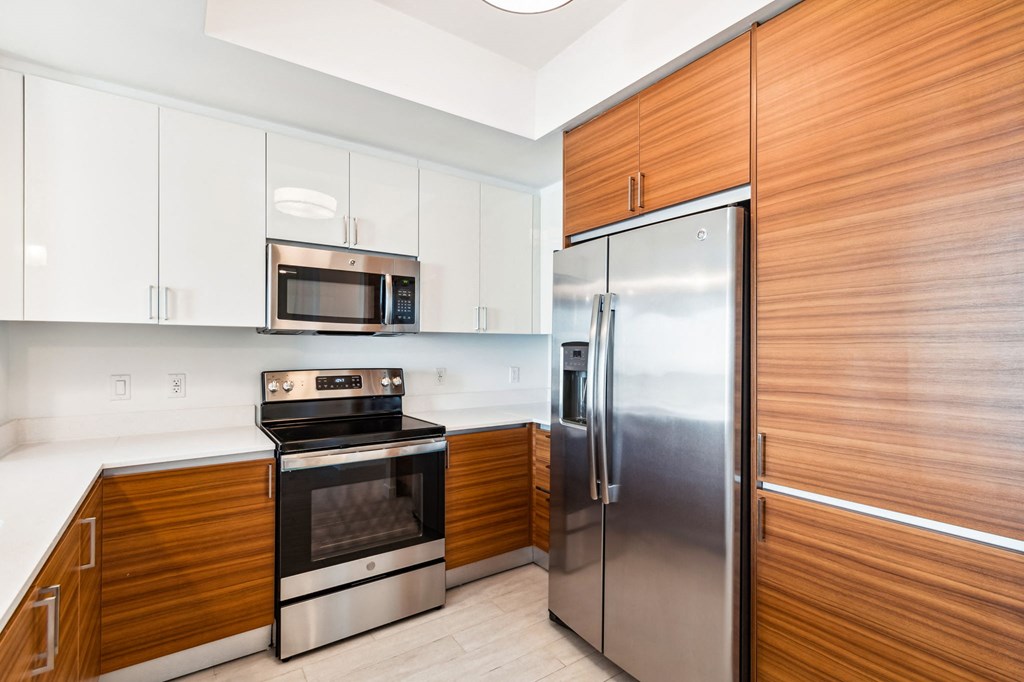 a kitchen with white cabinets and stainless steel appliances