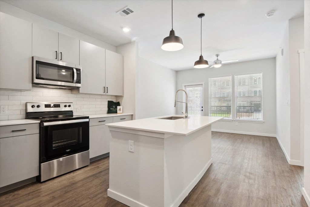 a kitchen with white cabinets and a white counter top