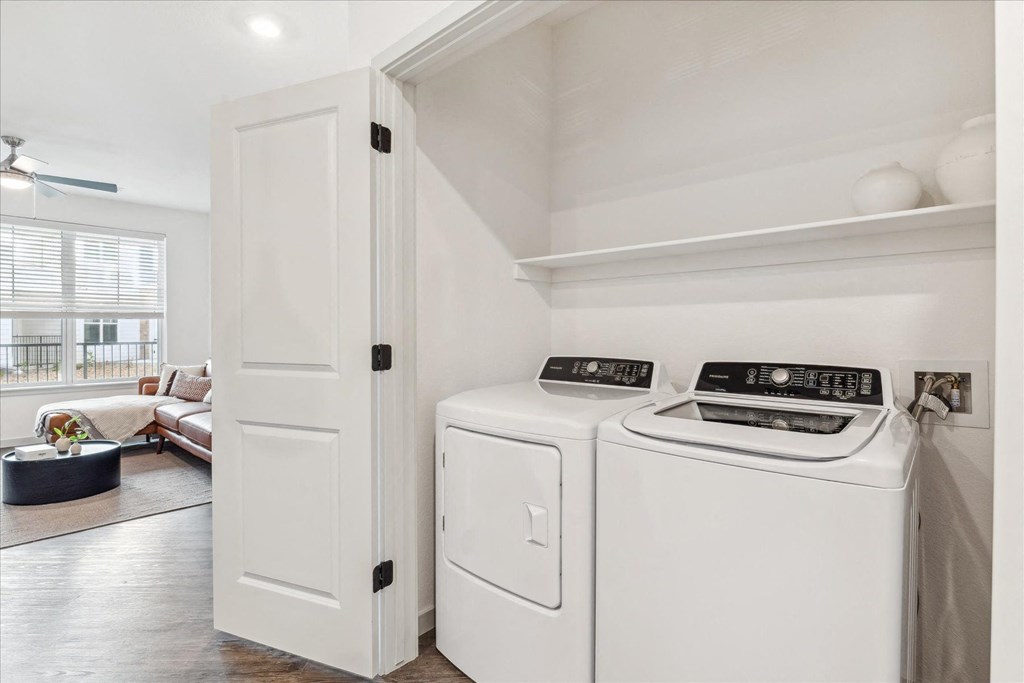 a washer and dryer in a laundry room next to a closet