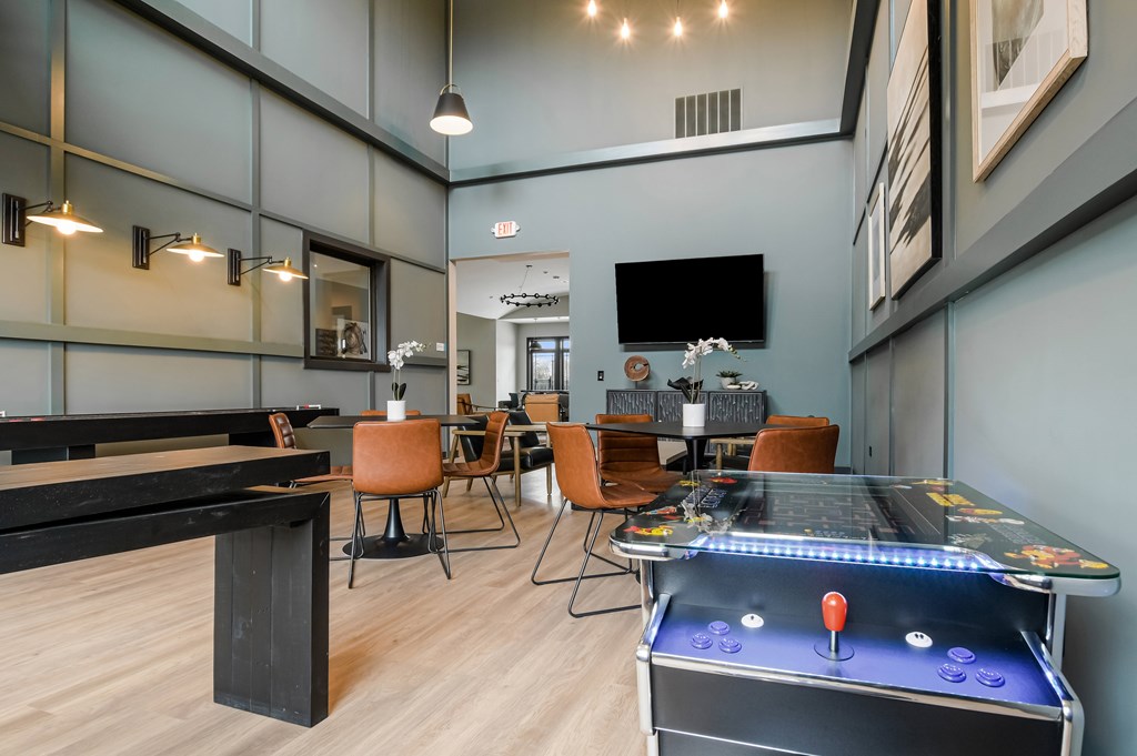 A room with a pool table and a TV.