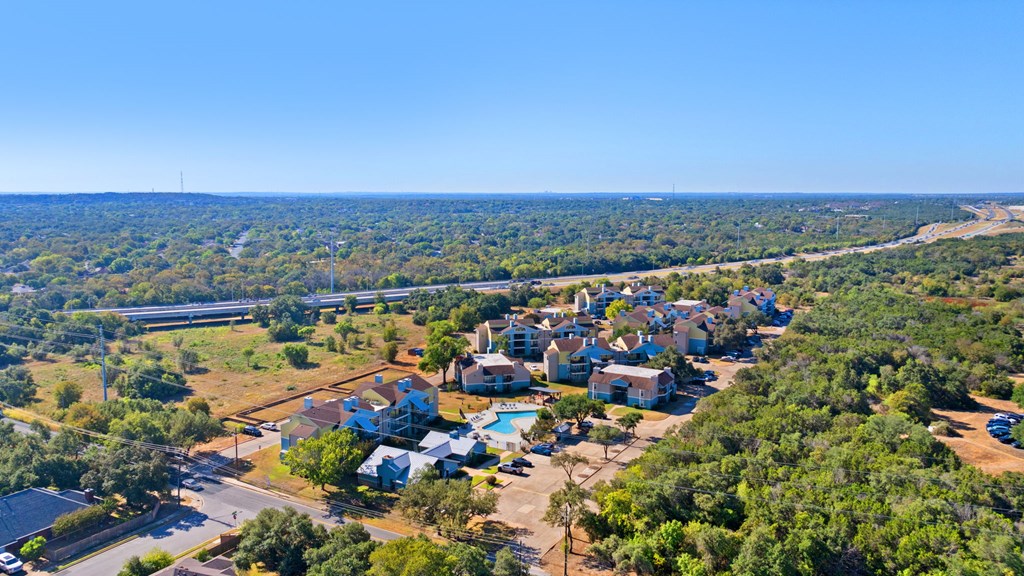 A bird's eye view of a resort surrounded by trees.