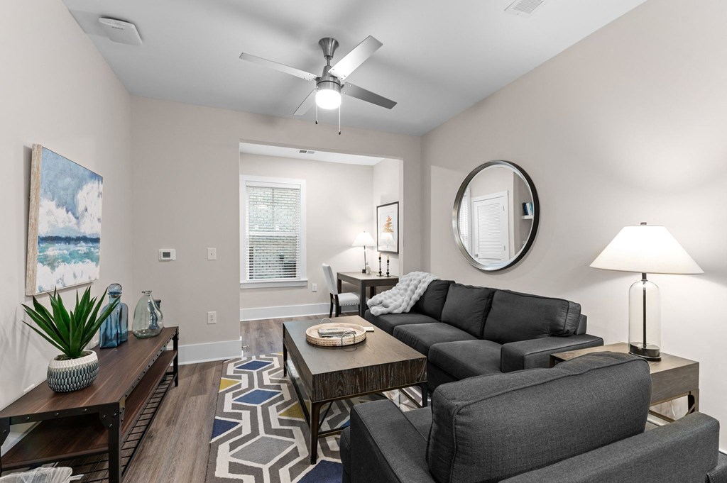 a living room with a couch and a ceiling fan