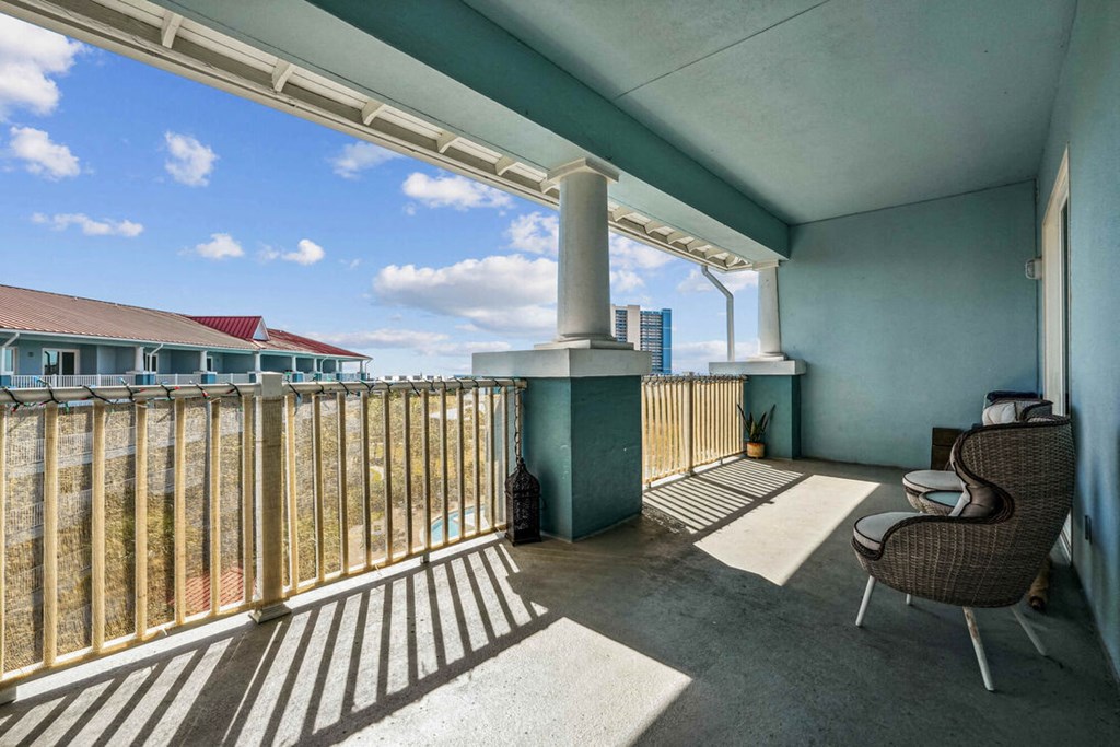 A balcony with a chair and a table.