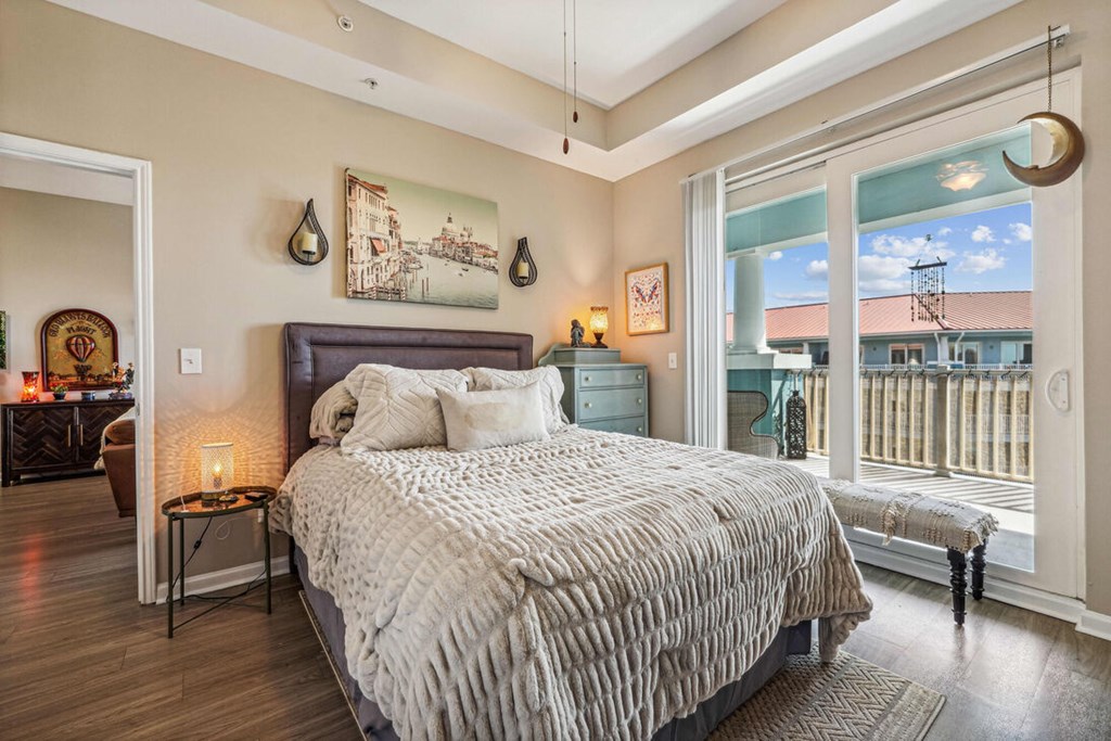 A bedroom with a large bed and a view of the city.