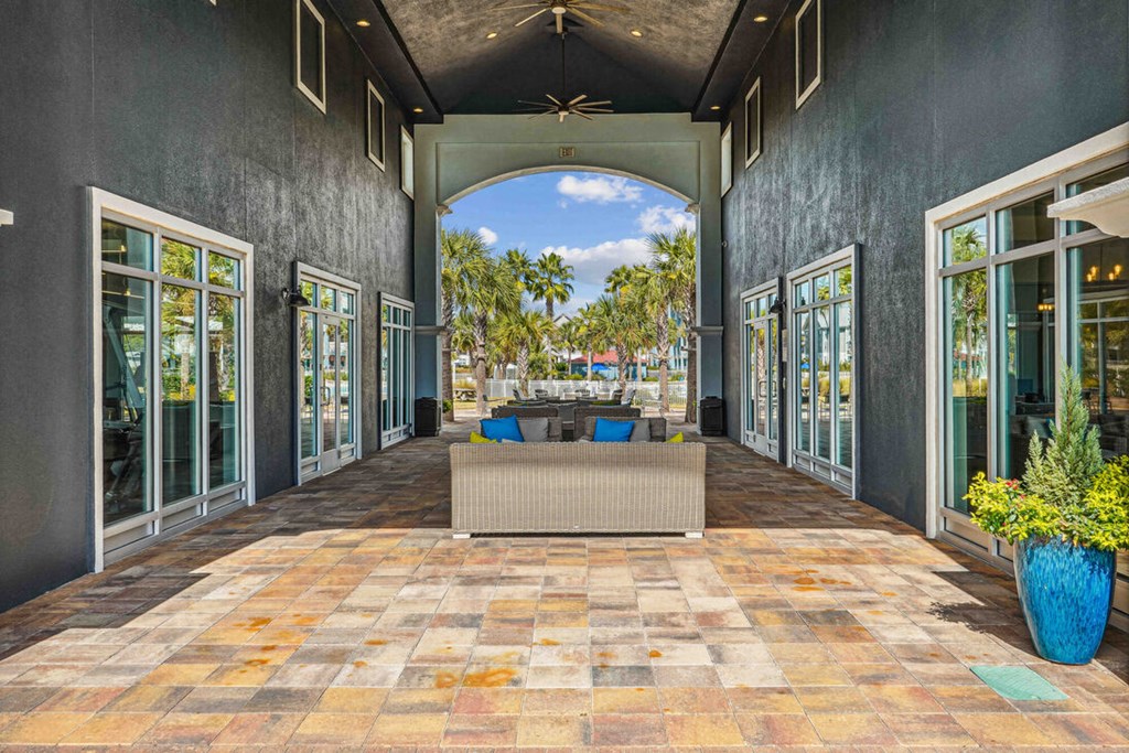 A patio with a tiled floor and a blue planter.