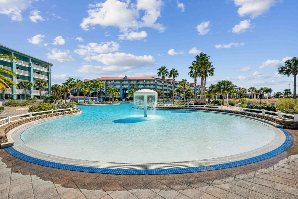 A round swimming pool with a fountain in the middle.