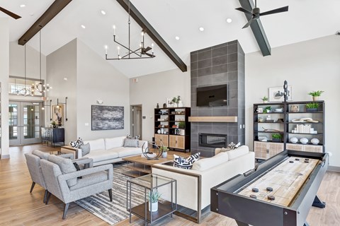 A modern living room with a pool table and a fireplace.