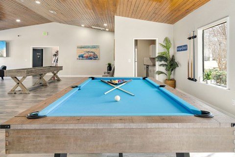 a pool table in a living room with a ball