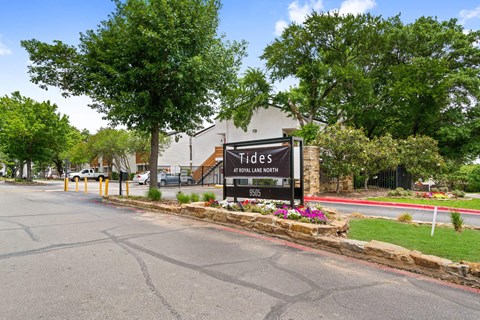 the sign at the entrance of tides on the street