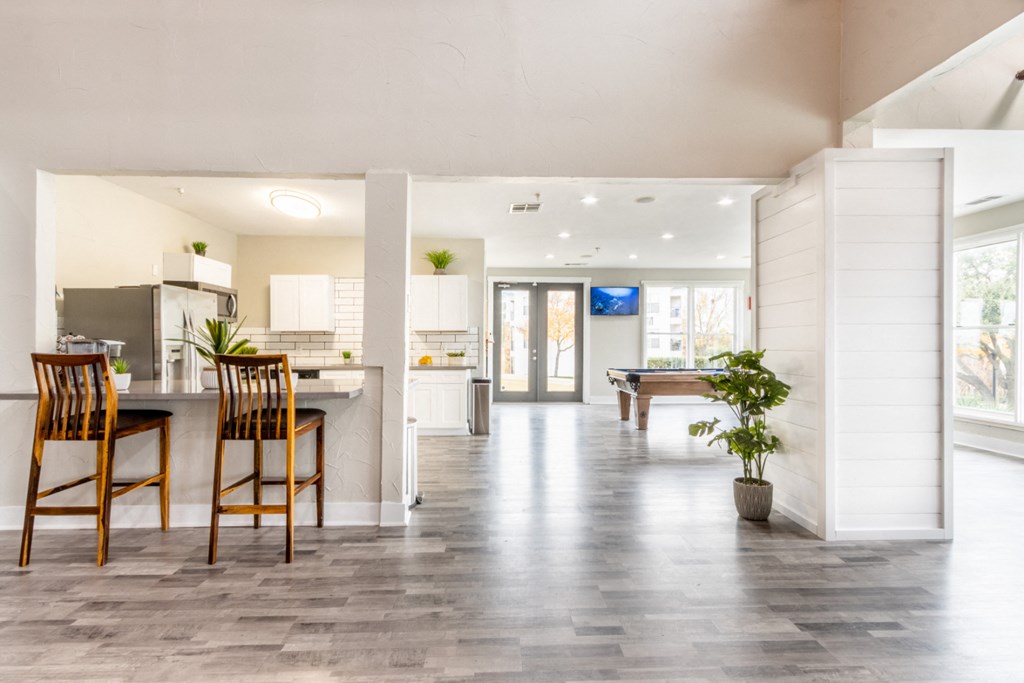 an open floor plan with a pool table and kitchen