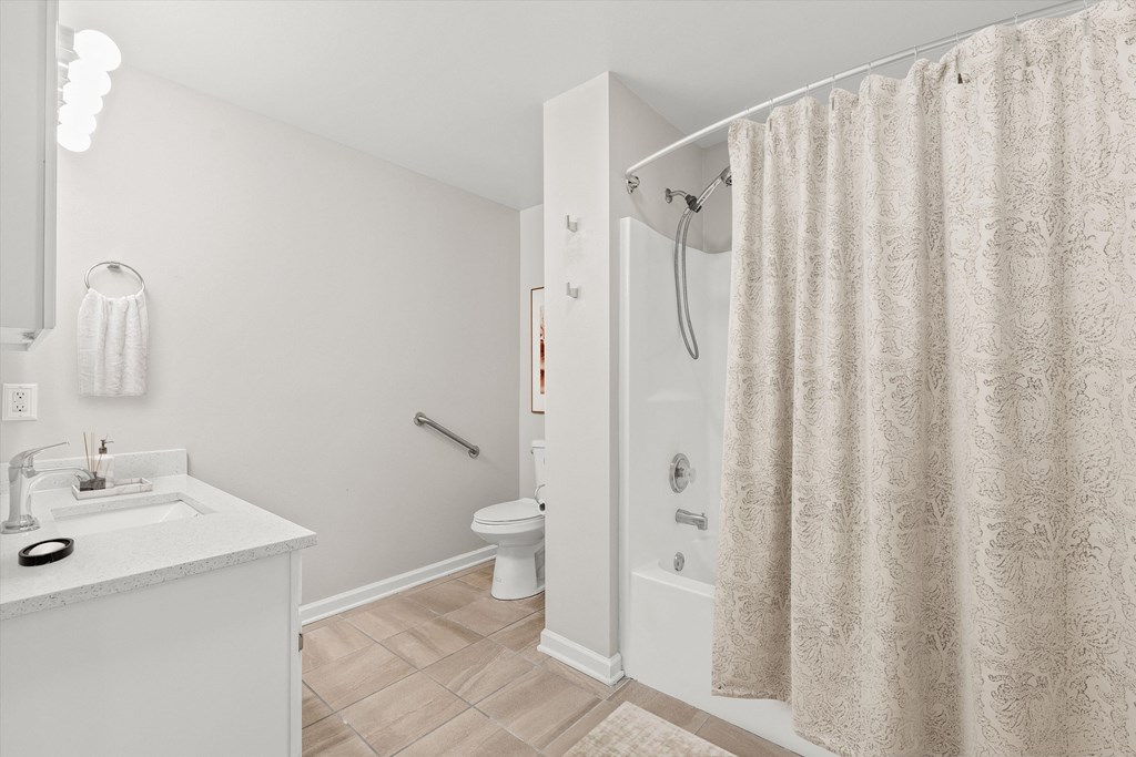 a bathroom with a shower and a sink and a toilet