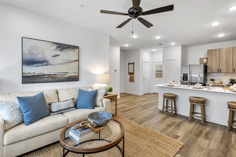A living room with a white couch and a coffee table.