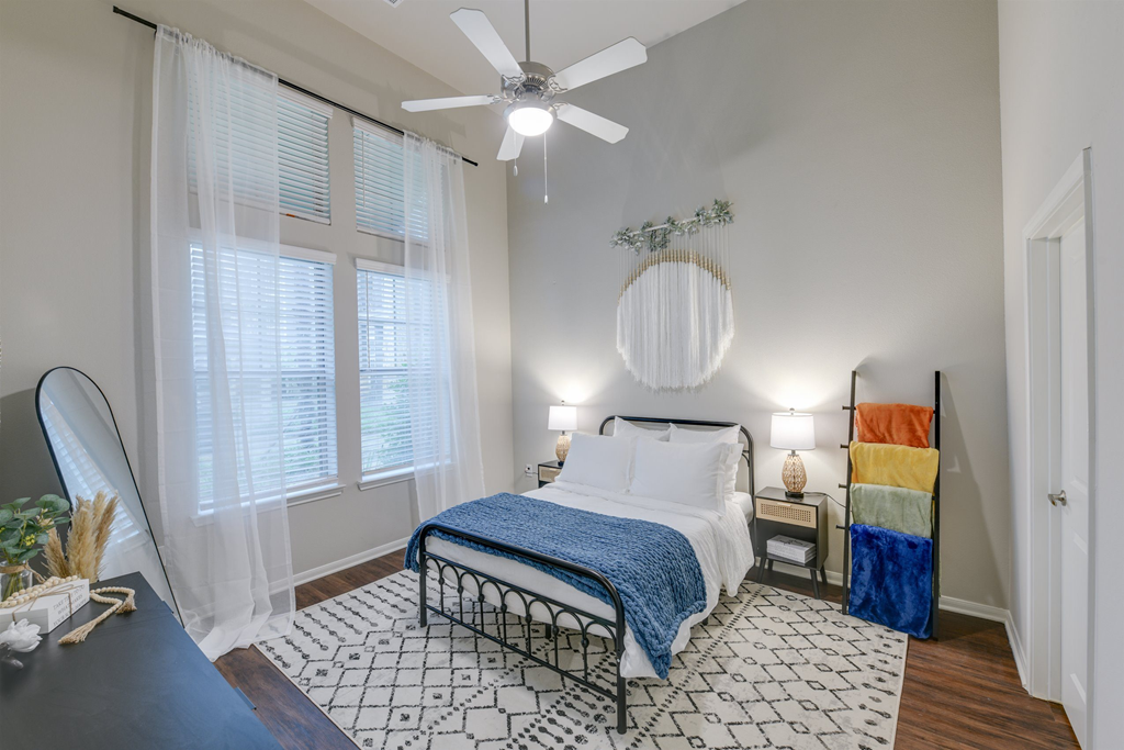 a bedroom with a bed and a ceiling fan