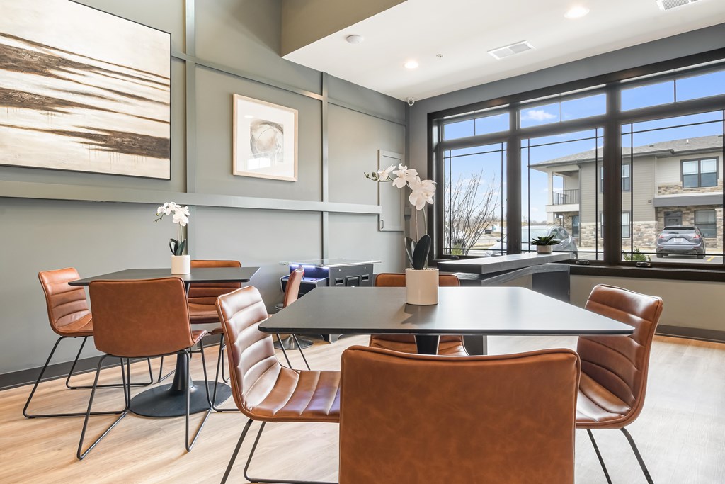 A dining room with a table and chairs.