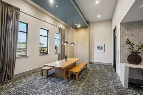 A dining room with a wooden table and benches.
