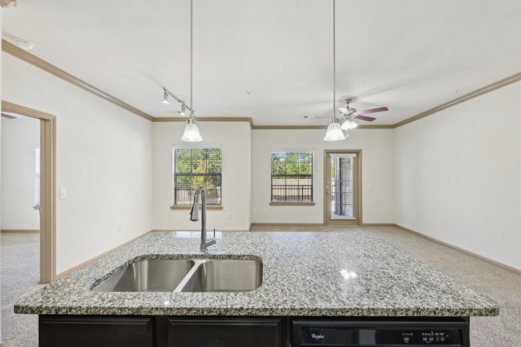 A kitchen with granite countertops and a sink.