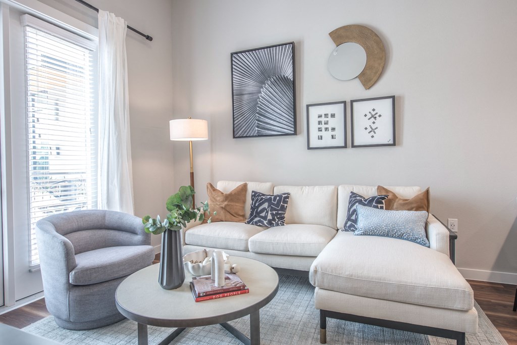 a living room with a couch and a chair and a coffee table