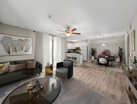 A modern living room with a glass coffee table and a grey sofa.