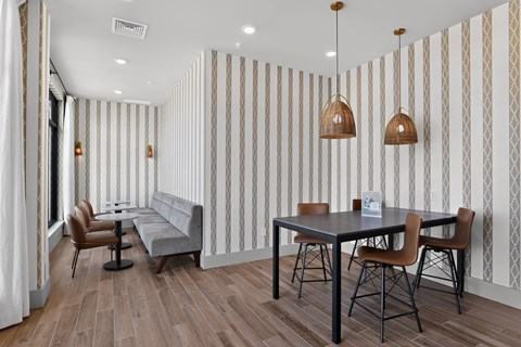 A dining room with a table and chairs.