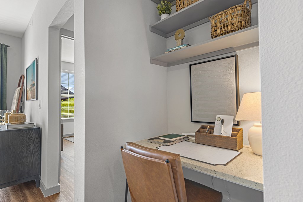 a home office with a desk and a window