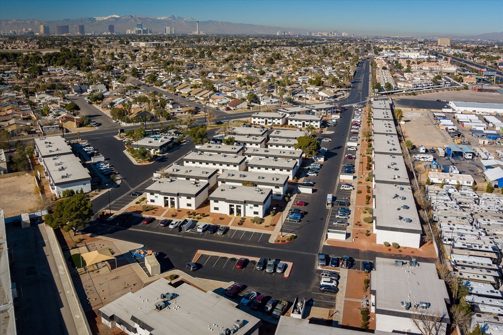 an aerial view of a city with a mountain range in the background