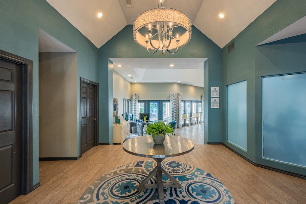 a large lobby with a table and a chandelier