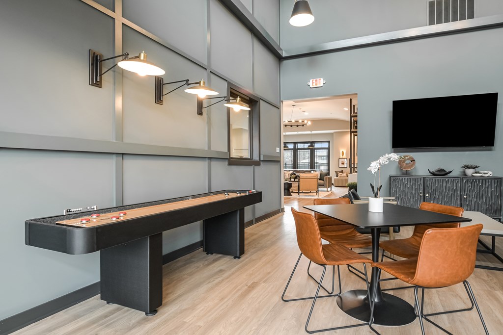 A room with a pool table and a tv.