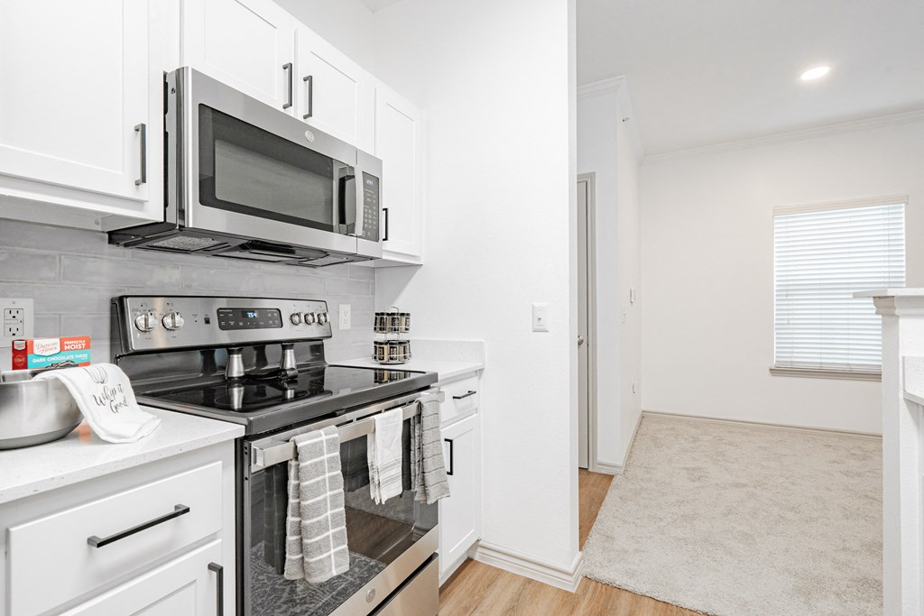 a kitchen with stainless steel appliances and a microwave
