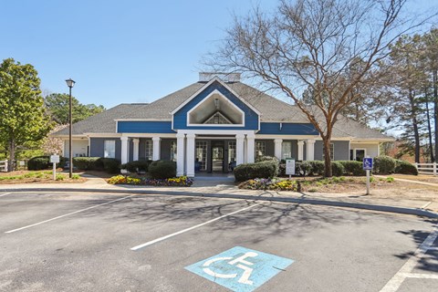 A parking lot with a handicap parking space in front of a building.