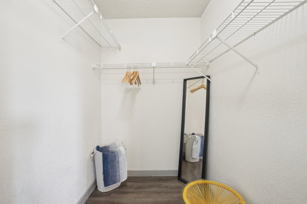 A laundry room with a clothesline, mirror, and basket.