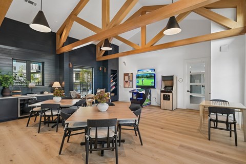 A modern dining area with a wooden table and chairs.
