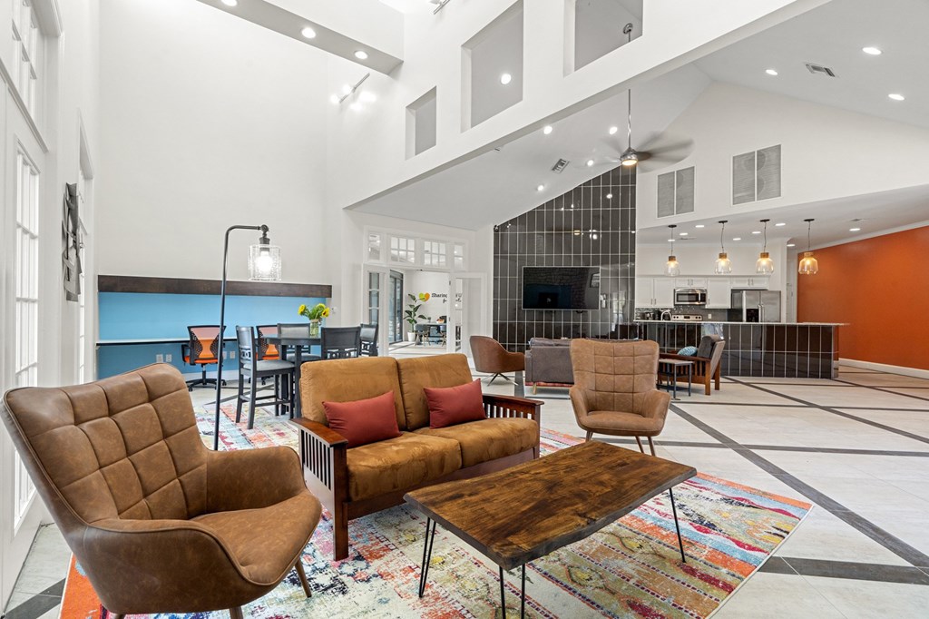 A living room with a brown chair and a brown couch.