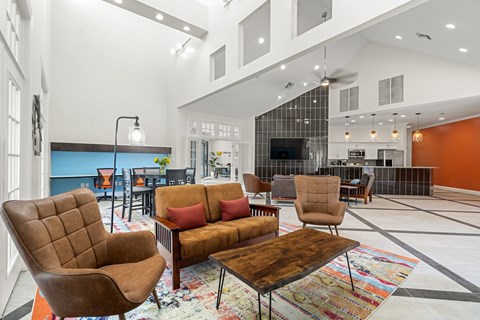 A living room with a brown chair and a brown couch.