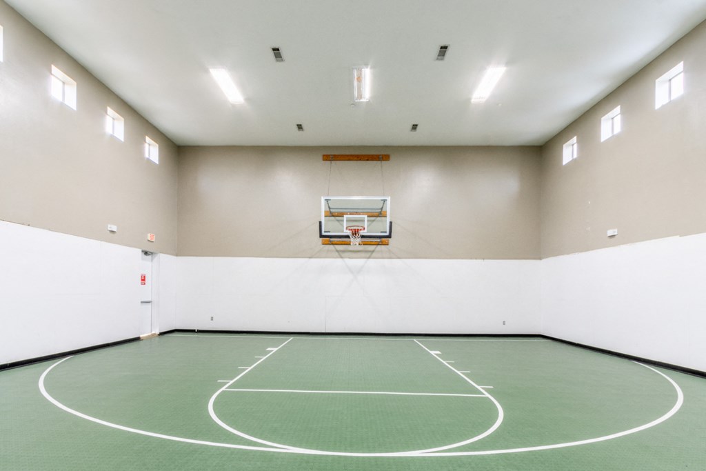 a basketball court in an empty gym