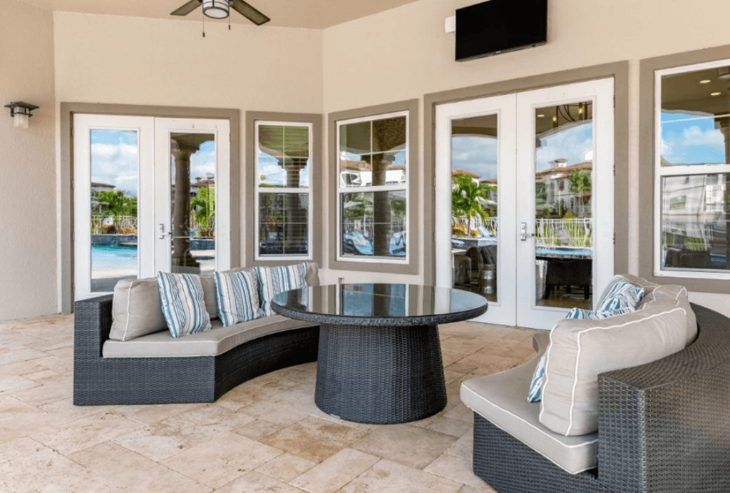 a patio with two couches and a table