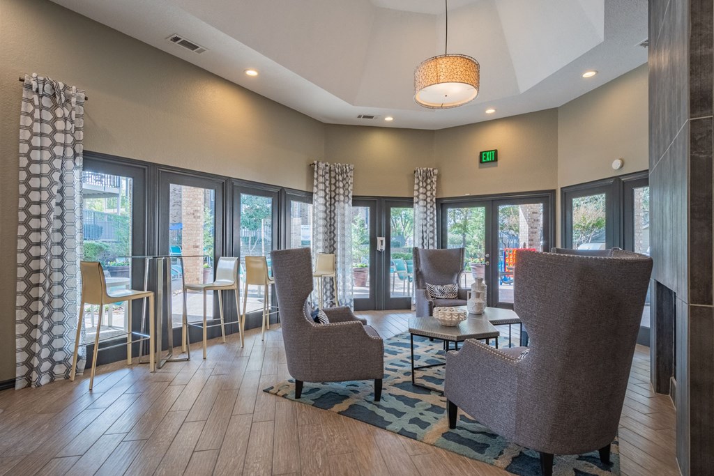 a resident lobby with chairs and tables and windows